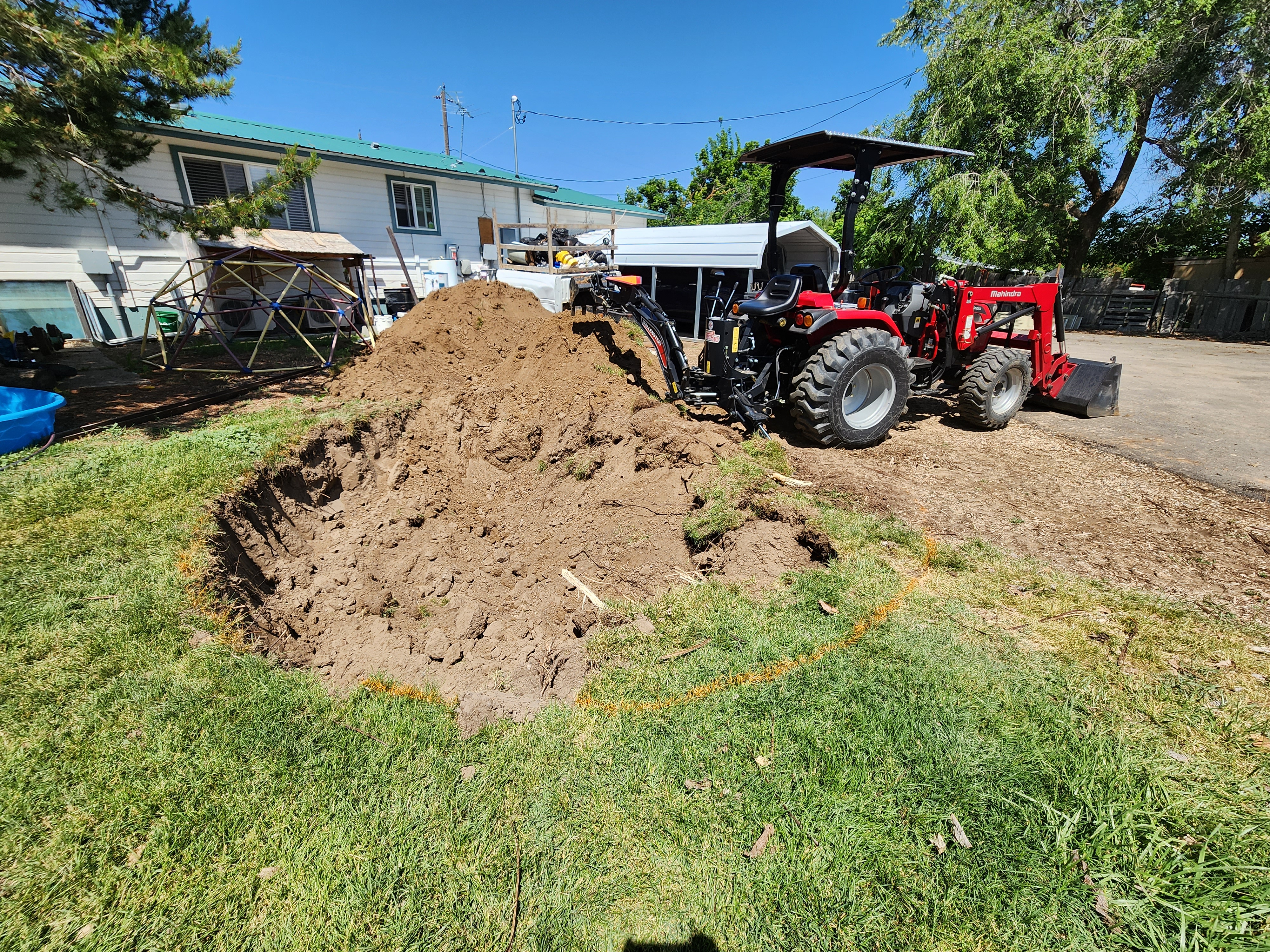 Backhoe digging a trench on a job site